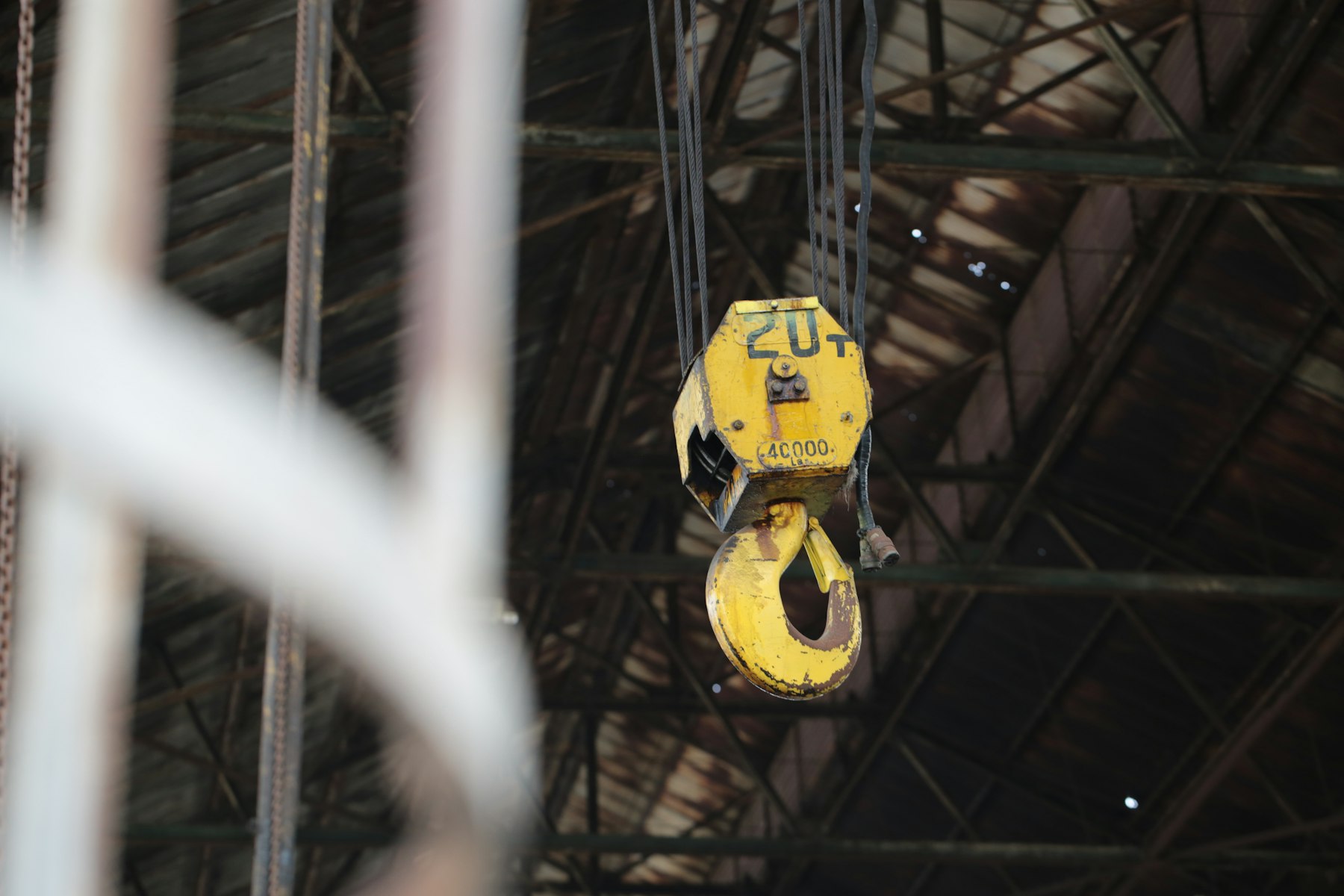 Overhead crane block in a steel-truss workshop