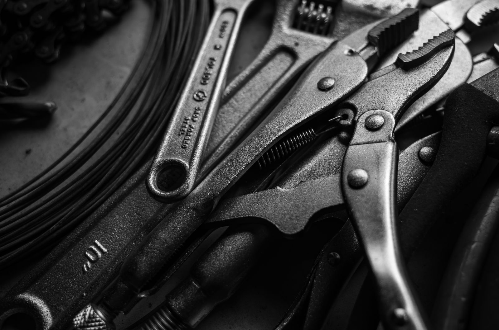 Locking pliers, wrenches and chain, close up
